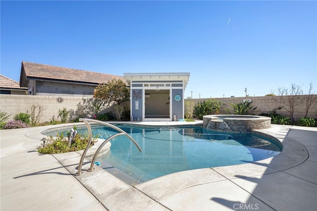 view of pool with a patio area, a pool with connected hot tub, an outdoor structure, and a fenced backyard