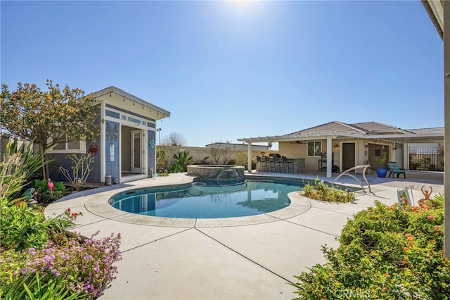 view of swimming pool featuring a patio area, a fenced backyard, a pool with connected hot tub, and outdoor dry bar