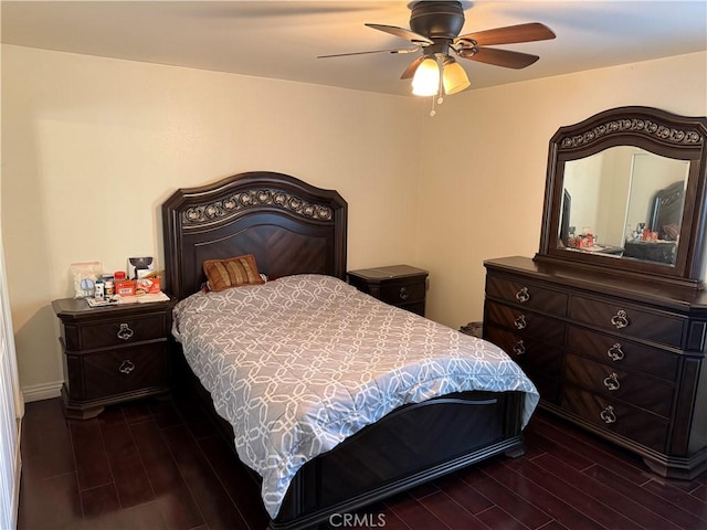 bedroom with dark wood-style floors and a ceiling fan