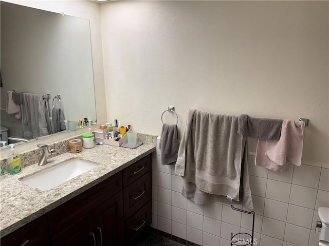 bathroom with tile walls and vanity