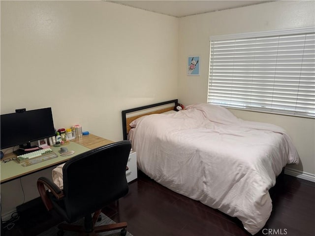 bedroom featuring wood finished floors