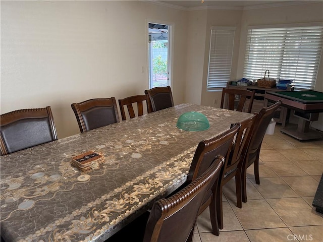 dining space with light tile patterned floors and ornamental molding