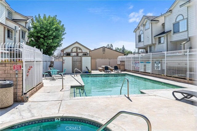 11150 Glenoaks Blvd Unit 266, Pacoima, CA 91331 - community pool with a storage unit, a patio, an outdoor structure, and fence