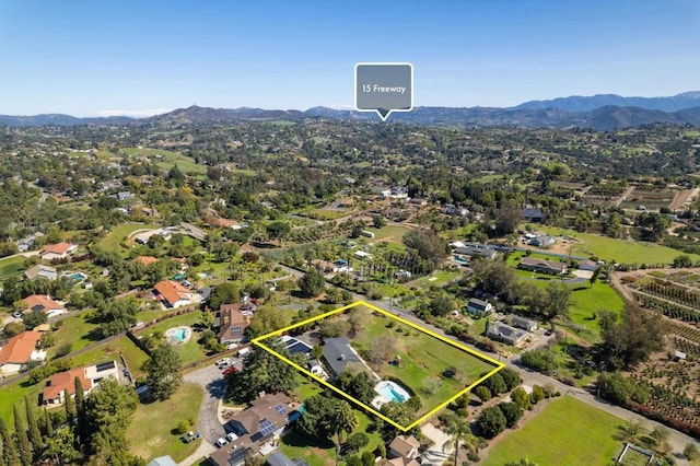 birds eye view of property featuring a mountain view