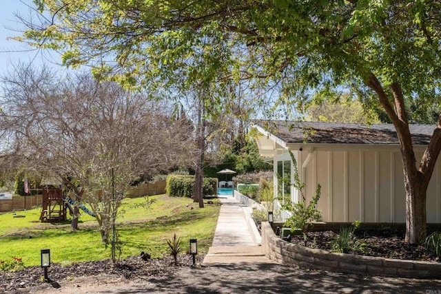 view of yard featuring fence and a playground