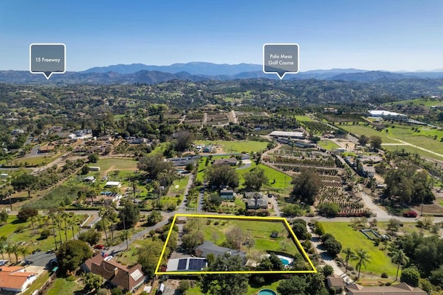 birds eye view of property with a mountain view