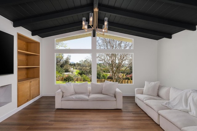 living room with a chandelier, a healthy amount of sunlight, vaulted ceiling with beams, and wood finished floors