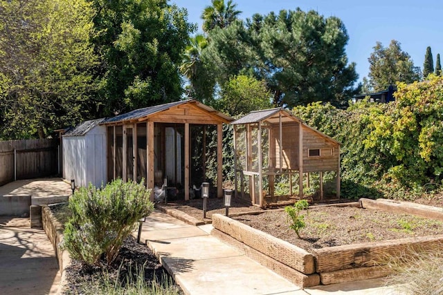 view of shed featuring fence