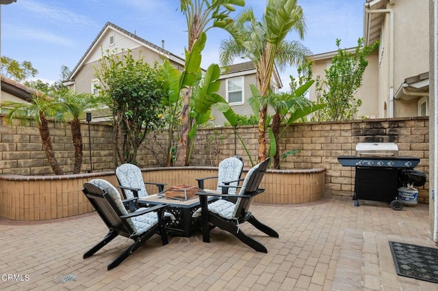 view of patio / terrace featuring area for grilling and fence