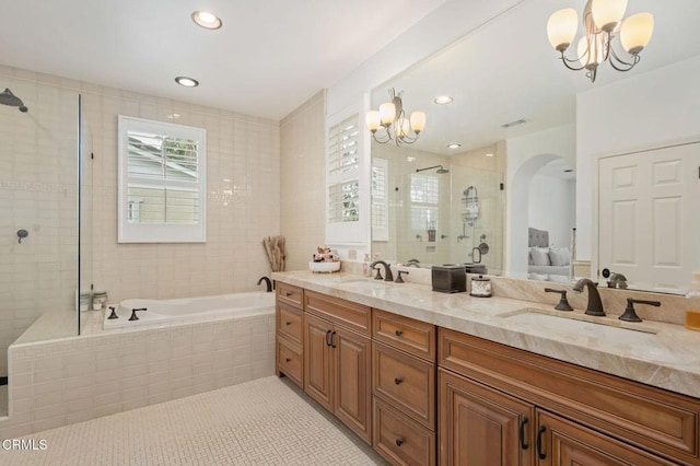 bathroom with a sink, tile patterned floors, a stall shower, and a chandelier