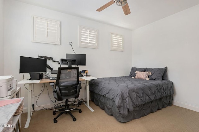 bedroom with a ceiling fan and baseboards