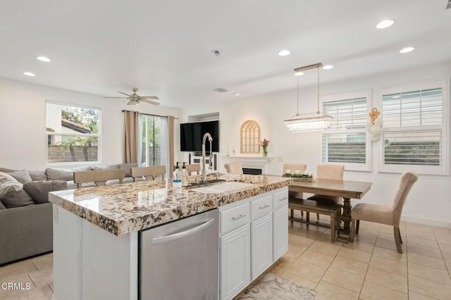 kitchen featuring a ceiling fan, a sink, hanging light fixtures, white cabinets, and stainless steel dishwasher