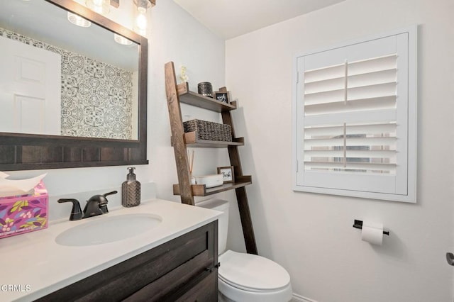 bathroom featuring toilet and vanity