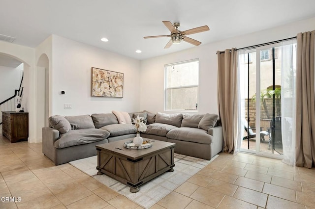 living area with visible vents, ceiling fan, recessed lighting, light tile patterned flooring, and arched walkways