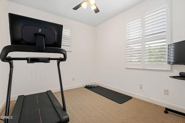 exercise room with baseboards, carpet, and ceiling fan