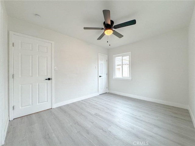 unfurnished bedroom with baseboards, light wood-style flooring, and a ceiling fan