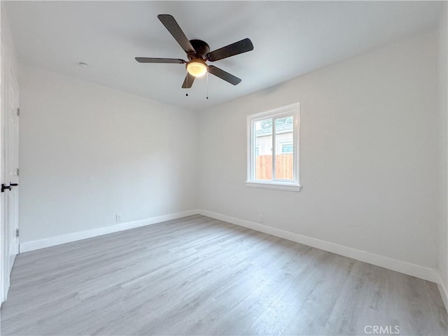 empty room with light wood-type flooring, baseboards, and ceiling fan