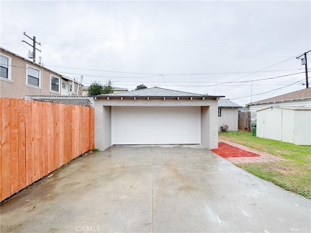 detached garage featuring fence