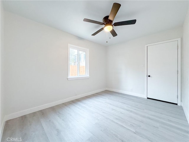 unfurnished bedroom featuring baseboards, light wood finished floors, and ceiling fan