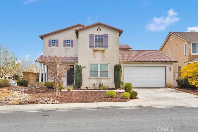 mediterranean / spanish-style home featuring a tile roof, an attached garage, driveway, and stucco siding