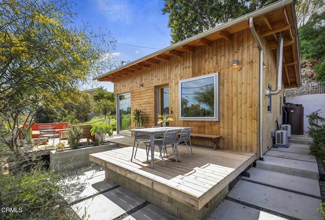 wooden terrace with outdoor dining area