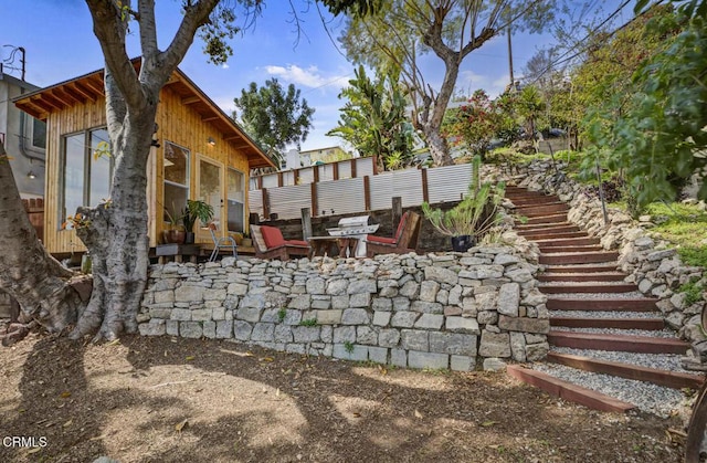 view of yard with stairs, a patio, and fence