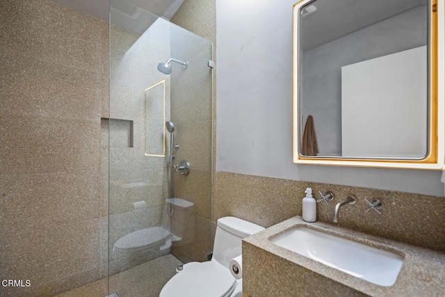 full bathroom with vanity, tile walls, toilet, and walk in shower