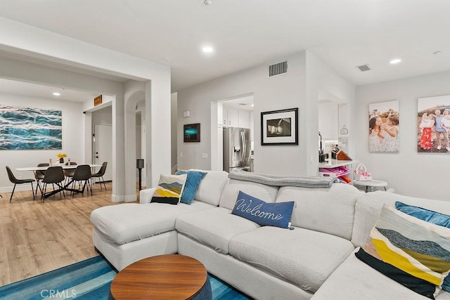 living room with visible vents, recessed lighting, baseboards, and wood finished floors