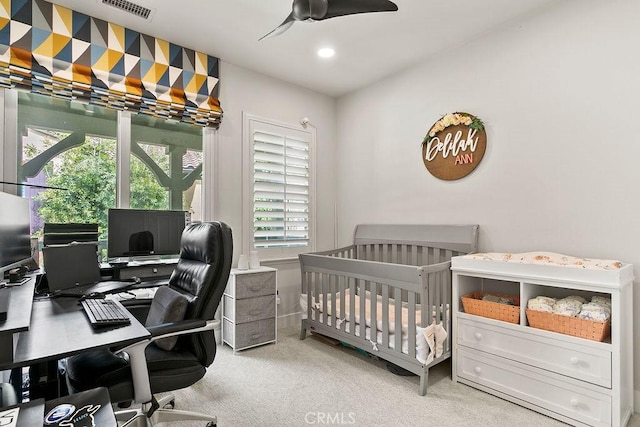 carpeted bedroom featuring recessed lighting, visible vents, a nursery area, and ceiling fan