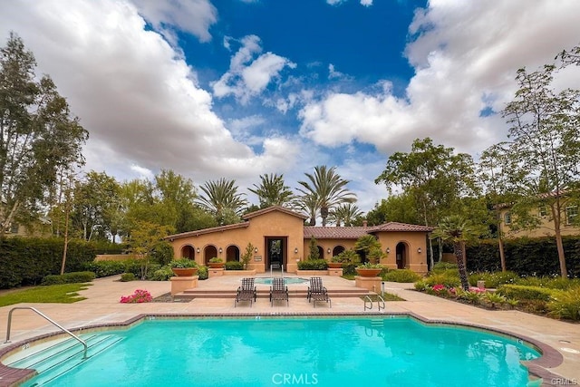 community pool with a patio area