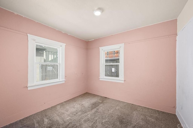 empty room featuring carpet flooring and a healthy amount of sunlight