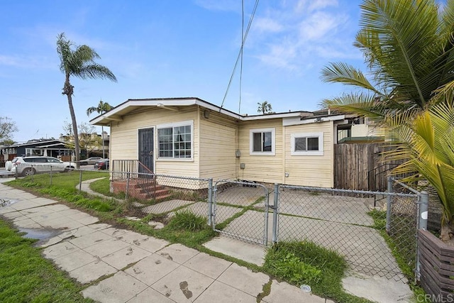 view of front of home with entry steps, a gate, and fence private yard