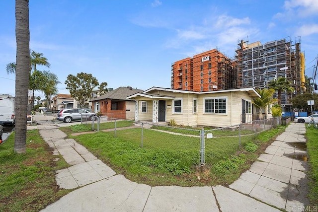 view of front of home with a front lawn and a fenced front yard