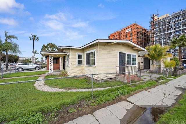 view of front of house with a front yard and a fenced front yard