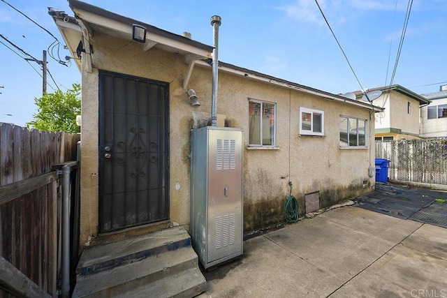 back of house with a patio, fence, and stucco siding