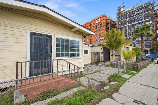 doorway to property with a gate and fence