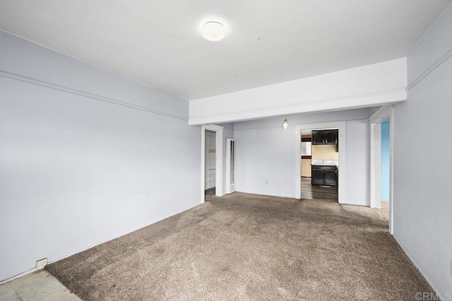 unfurnished living room featuring carpet flooring