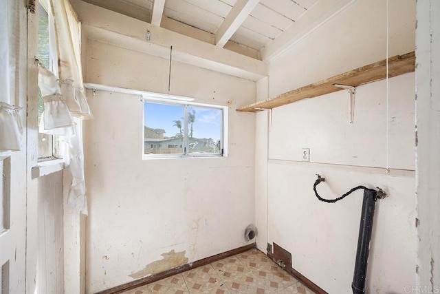 clothes washing area with light floors