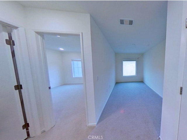 interior space featuring baseboards, visible vents, and carpet floors