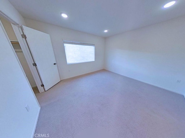 unfurnished bedroom with carpet flooring, recessed lighting, and baseboards