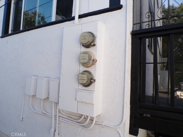 details with stucco siding and electric meter