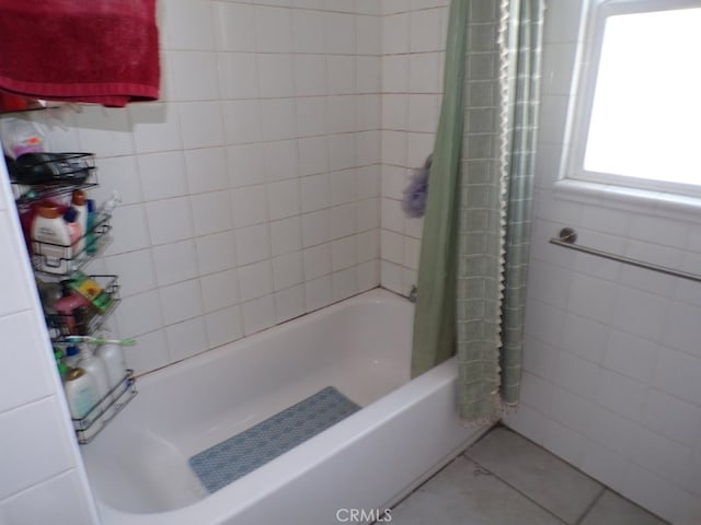 bathroom with tile patterned floors, tile walls, and shower / bath combo