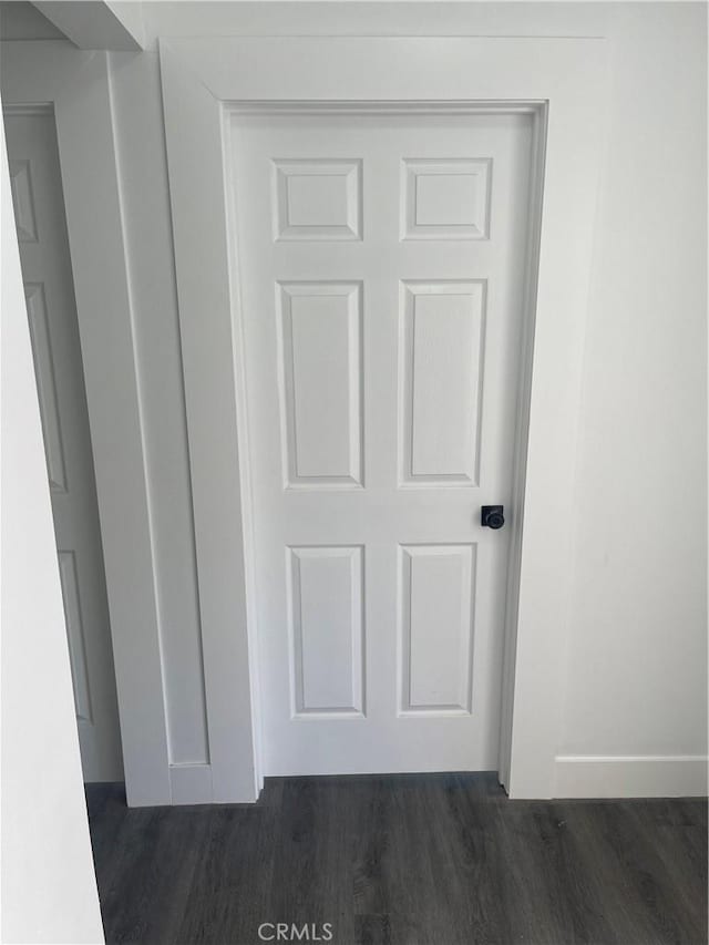 room details featuring baseboards and wood finished floors