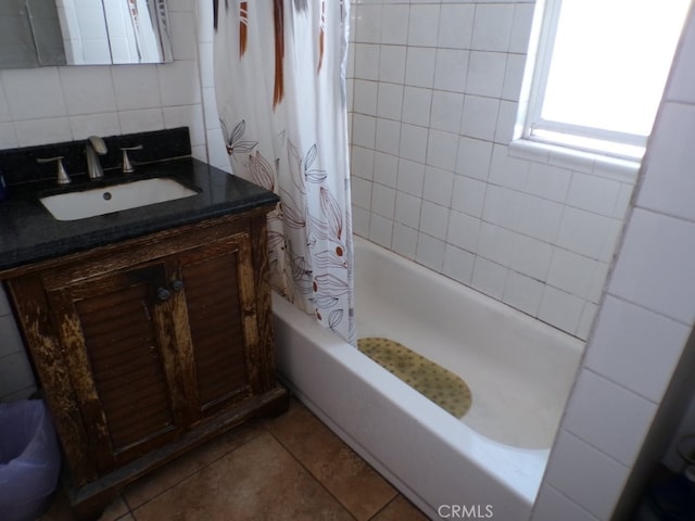 bathroom featuring vanity, tile patterned flooring, shower / bath combination with curtain, tile walls, and tasteful backsplash