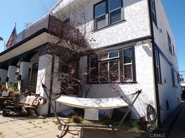 back of house featuring a patio area and stucco siding