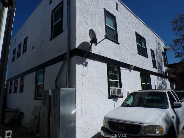 view of side of home featuring stucco siding