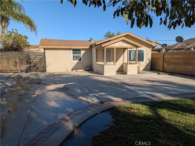 back of property featuring a patio area, stucco siding, and fence