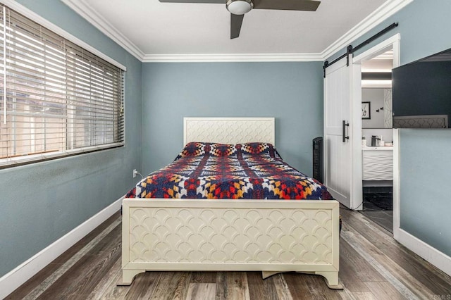 bedroom with crown molding, wood finished floors, and baseboards