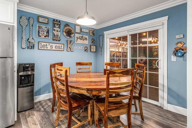 dining area with wood finished floors, baseboards, and ornamental molding