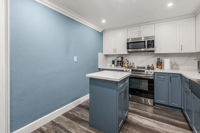 kitchen with white cabinetry, dark wood-style floors, tasteful backsplash, and stainless steel appliances